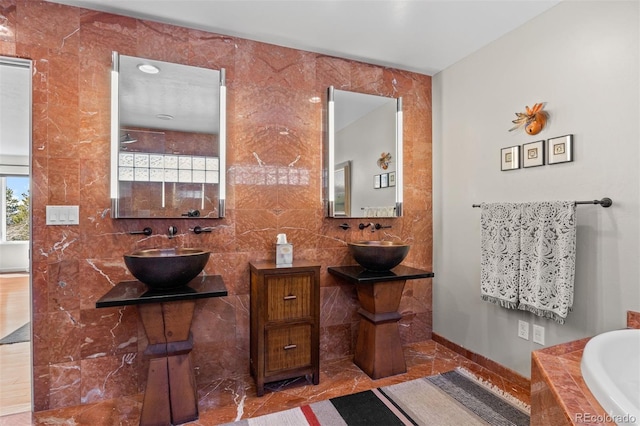 12653 Rancho Ct, Conifer, CO 80433 - bathroom with tiled bath, marble finish floors, and tile walls