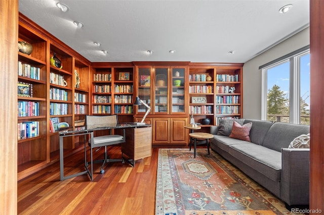 12653 Rancho Ct, Conifer, CO 80433 - office with light wood-style floors, bookshelves, wine cooler, and recessed lighting