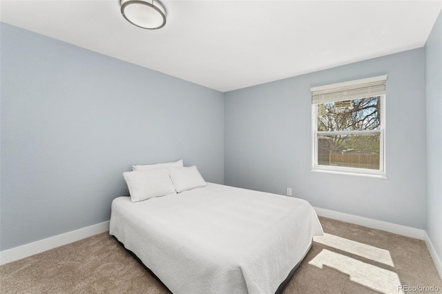 bedroom featuring carpet and baseboards