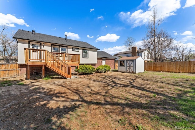 back of house featuring a storage shed, an outdoor structure, stucco siding, and a fenced backyard