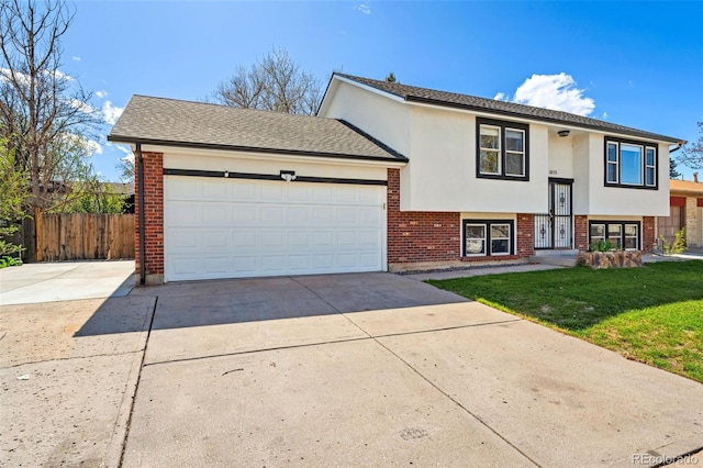 view of front of house featuring fence, a front lawn, brick siding, and concrete driveway