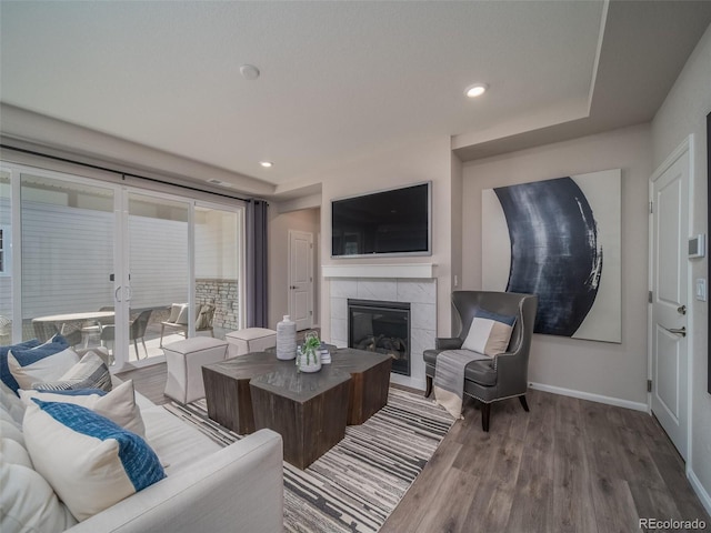 living room featuring hardwood / wood-style floors and a tile fireplace