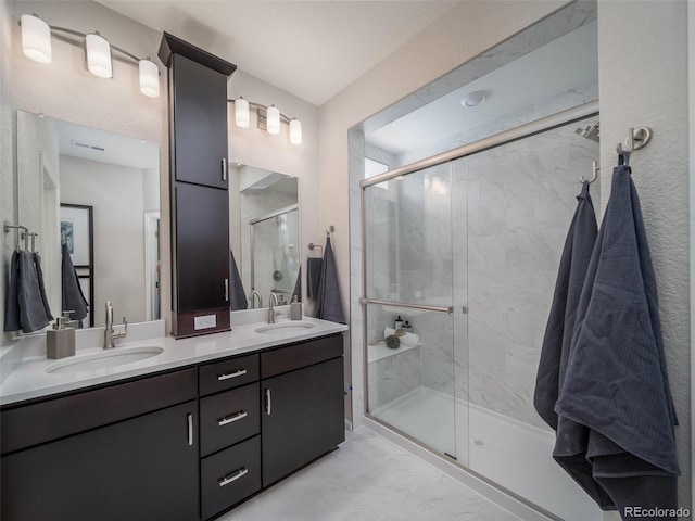 bathroom featuring vanity and a shower with shower door