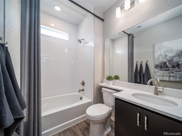 full bathroom with hardwood / wood-style flooring, shower / bath combination with curtain, toilet, and vanity