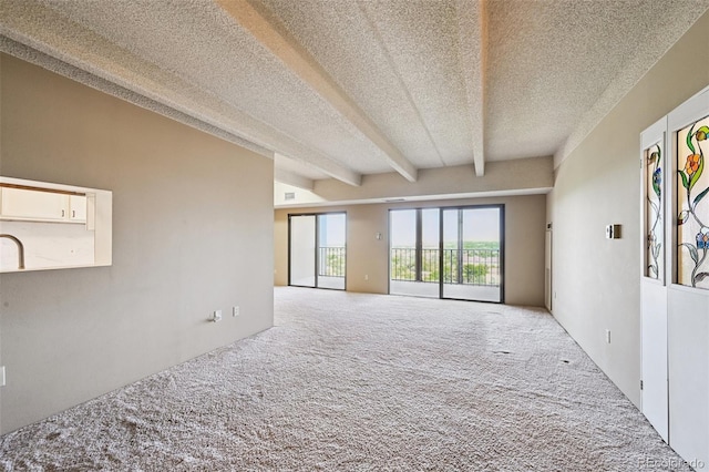 7865 E Mississippi Ave Unit 1504, Denver, CO 80247 - spare room featuring carpet floors, a textured ceiling, and beamed ceiling