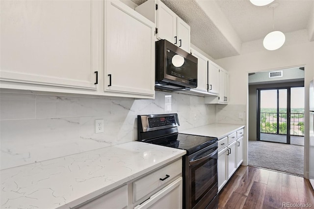 7865 E Mississippi Ave Unit 1504, Denver, CO 80247 - kitchen with electric stove, black microwave, white cabinets, dark wood-style floors, and backsplash