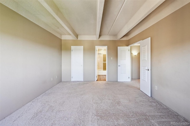 7865 E Mississippi Ave Unit 1504, Denver, CO 80247 - unfurnished bedroom featuring carpet, ensuite bath, and beamed ceiling