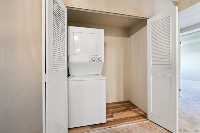 7865 E Mississippi Ave Unit 1504, Denver, CO 80247 - laundry area with stacked washing machine and dryer and carpet floors