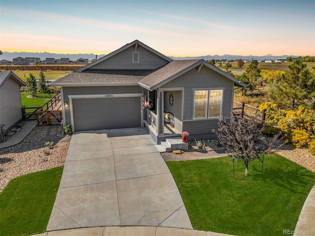 view of front of home featuring a garage and a lawn