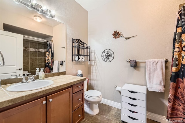 bathroom featuring toilet, tile patterned flooring, vanity, baseboards, and a shower with shower curtain