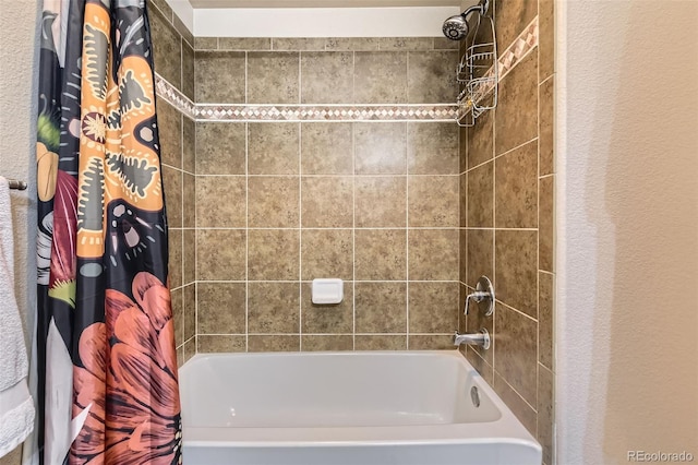 bathroom featuring shower / tub combo with curtain and a textured wall