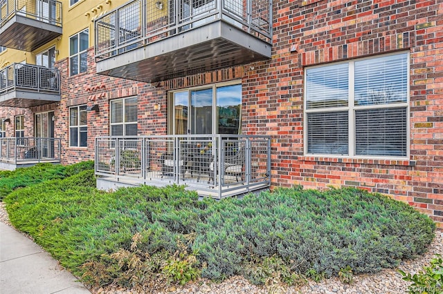 entrance to property featuring brick siding