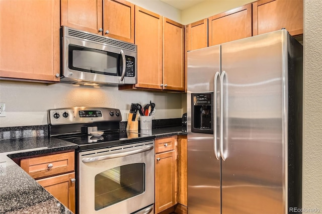9019 E Panorama Cir Unit D207, Englewood, CO 80112 - kitchen featuring appliances with stainless steel finishes and dark stone counters