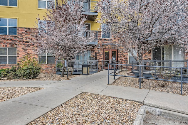 9019 E Panorama Cir Unit D207, Englewood, CO 80112 - view of front of home featuring brick siding and stucco siding