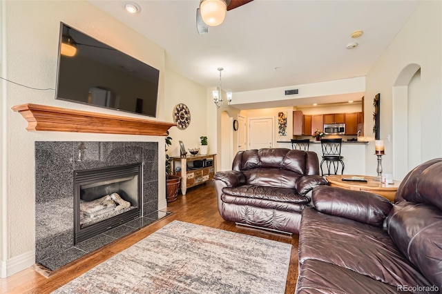 9019 E Panorama Cir Unit D207, Englewood, CO 80112 - living area with wood finished floors, a fireplace, and arched walkways