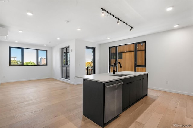 1601 Park Ave Unit 307, Denver, CO 80218 - kitchen with a sink, dark cabinets, a kitchen island with sink, light wood-style floors, and recessed lighting