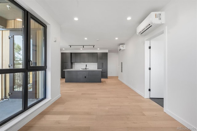 1601 Park Ave Unit 307, Denver, CO 80218 - corridor with a wall mounted air conditioner, a sink, light wood-style floors, track lighting, and recessed lighting