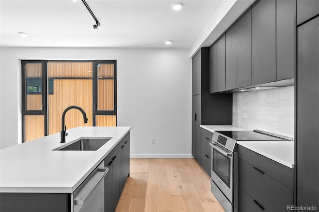 1601 Park Ave Unit 307, Denver, CO 80218 - kitchen featuring appliances with stainless steel finishes, a sink, modern cabinets, and recessed lighting