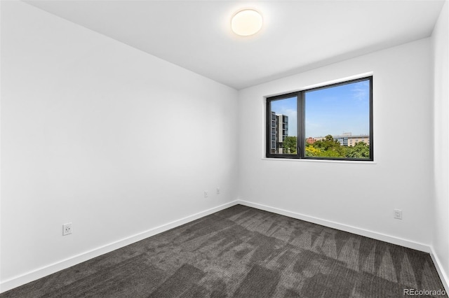 1601 Park Ave Unit 307, Denver, CO 80218 - empty room with baseboards and dark colored carpet