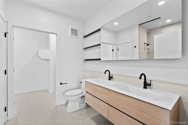 1601 Park Ave Unit 307, Denver, CO 80218 - bathroom featuring double vanity, toilet, a shower, recessed lighting, and tile patterned floors