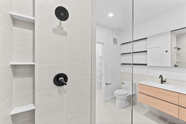 1601 Park Ave Unit 307, Denver, CO 80218 - bathroom with tiled shower, vanity, toilet, and tile patterned floors