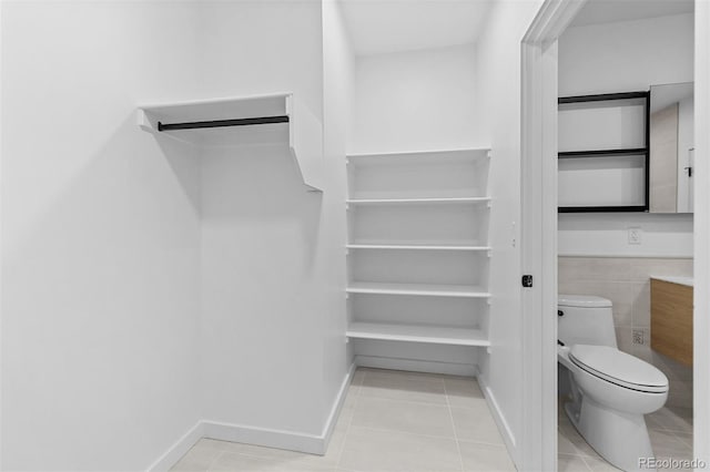 1601 Park Ave Unit 307, Denver, CO 80218 - walk in closet featuring tile patterned flooring