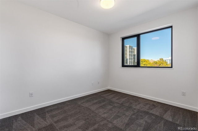 1601 Park Ave Unit 307, Denver, CO 80218 - empty room with dark colored carpet and baseboards
