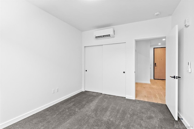 1601 Park Ave Unit 307, Denver, CO 80218 - unfurnished bedroom featuring a wall mounted AC, carpet flooring, a closet, recessed lighting, and baseboards