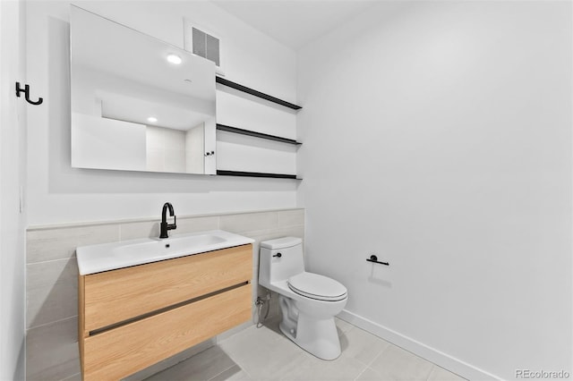1601 Park Ave Unit 307, Denver, CO 80218 - bathroom with tile walls, toilet, vanity, and tile patterned flooring