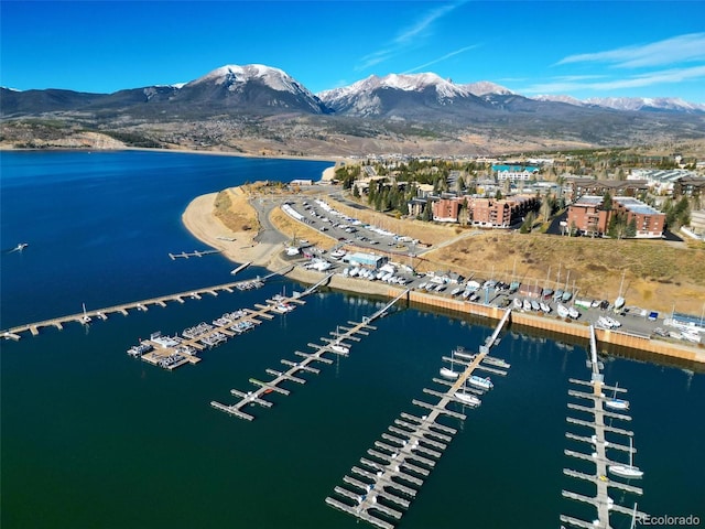 drone / aerial view featuring a water and mountain view