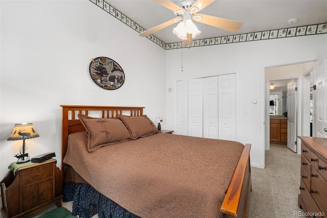 carpeted bedroom with a closet and ceiling fan