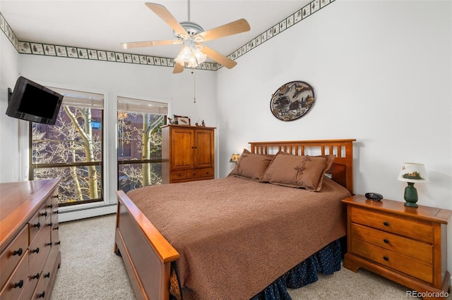 bedroom featuring ceiling fan, multiple windows, light colored carpet, and a baseboard heating unit