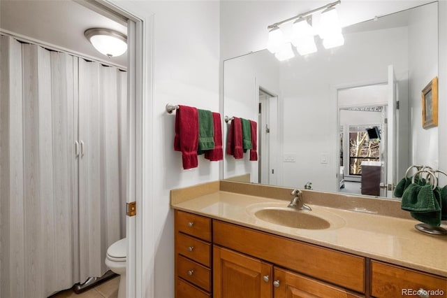 bathroom with vanity, toilet, and tile patterned flooring