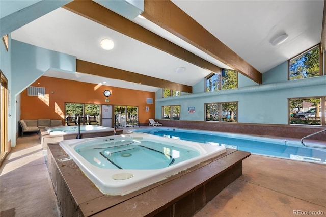 view of swimming pool with an indoor hot tub