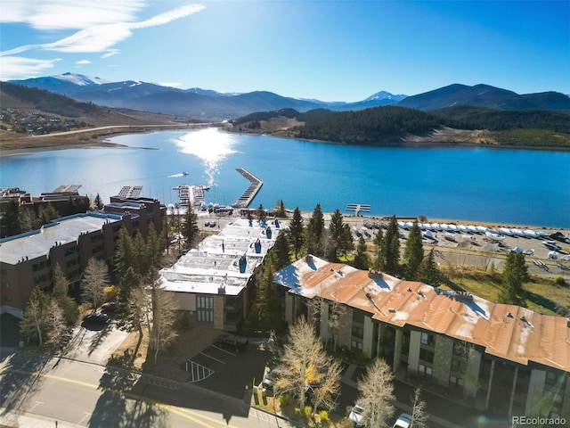 drone / aerial view featuring a water and mountain view