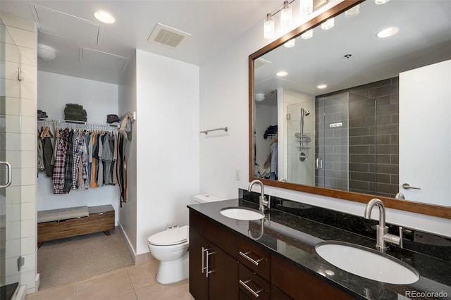 full bathroom with tile patterned flooring, a shower stall, double vanity, a spacious closet, and recessed lighting