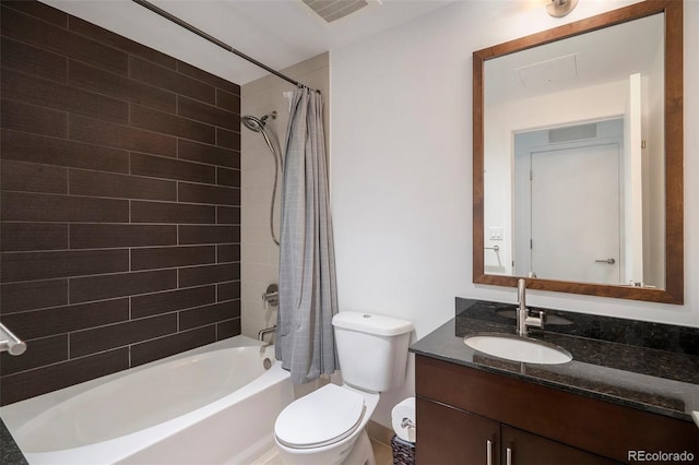 bathroom with shower / bathtub combination with curtain, vanity, and toilet