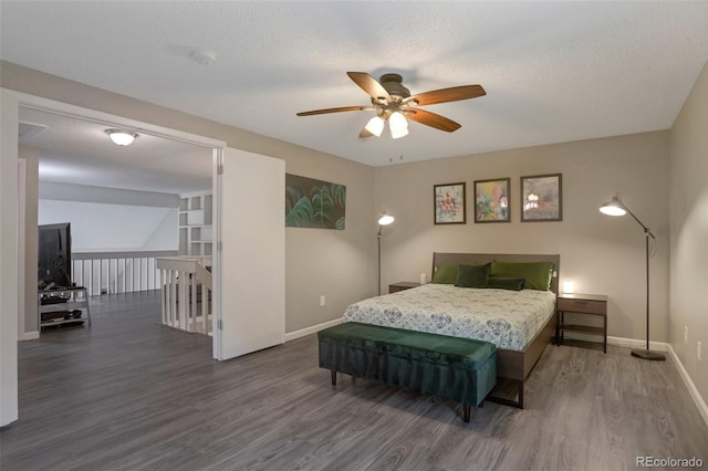 11894 Elk Head Range Rd, Littleton, CO 80127 - bedroom featuring wood finished floors, a textured ceiling, and ceiling fan