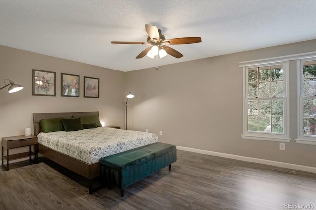 11894 Elk Head Range Rd, Littleton, CO 80127 - bedroom with dark wood-style floors, ceiling fan, and a textured ceiling