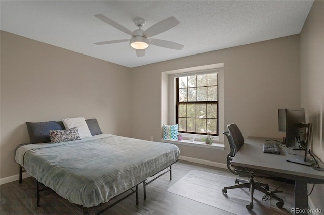 11894 Elk Head Range Rd, Littleton, CO 80127 - bedroom with wood finished floors, an office area, and a ceiling fan