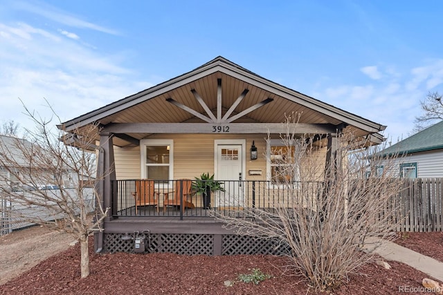 bungalow featuring fence and covered porch