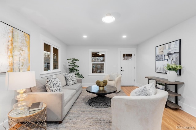 living room featuring recessed lighting, light wood-type flooring, and baseboards