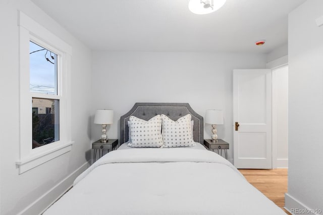 bedroom featuring baseboards and wood finished floors