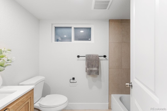 bathroom with vanity, a tub to relax in, visible vents, baseboards, and toilet