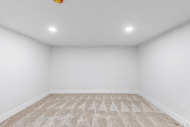 unfurnished room with recessed lighting, baseboards, and light colored carpet