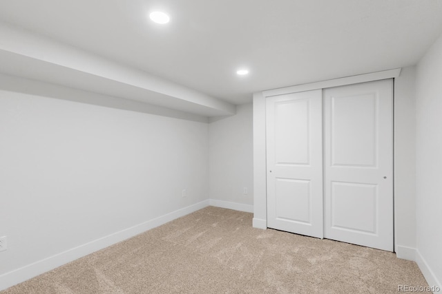 finished below grade area featuring recessed lighting, baseboards, and light carpet