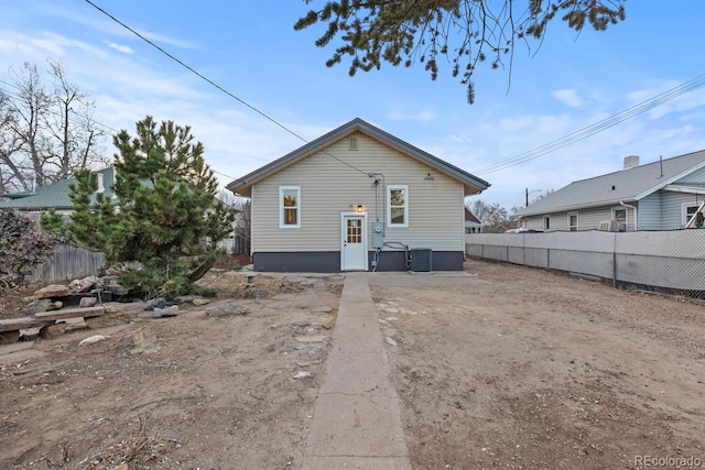 back of property with central air condition unit and fence