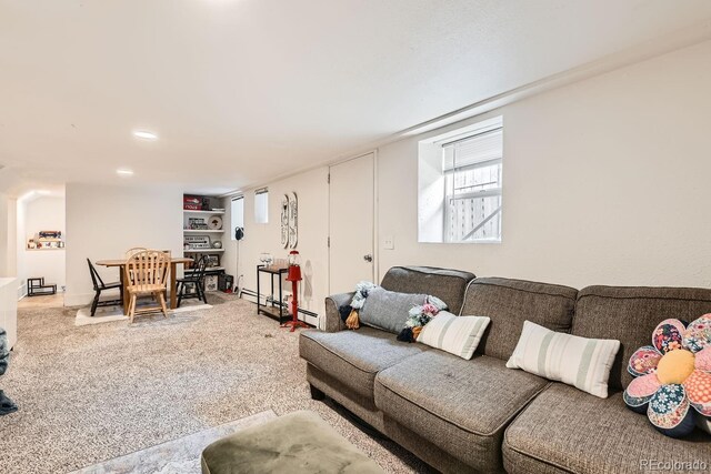 living room with a baseboard radiator and carpet flooring