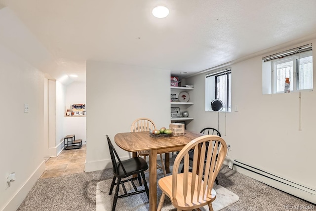 carpeted dining room with a baseboard radiator