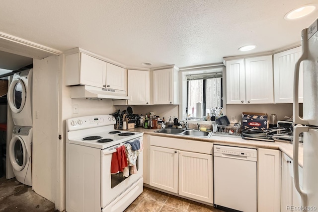 kitchen with sink, white appliances, stacked washer / dryer, a textured ceiling, and white cabinets